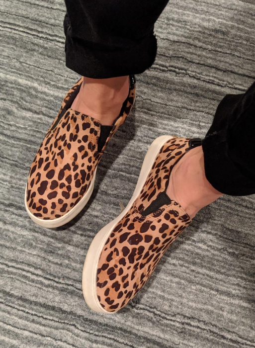 reviewer rocking the leopard print Dr. Scholl's sneakers