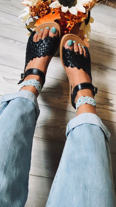 A model wearing the black sandals