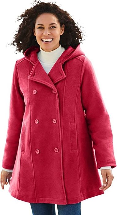 A model wearing a red coat paired with blue bottoms