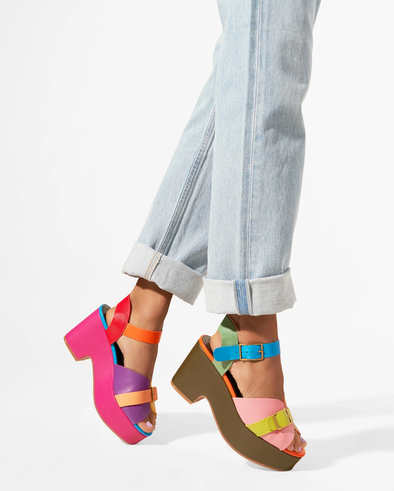 A model showcasing the multi-colored platform sandals