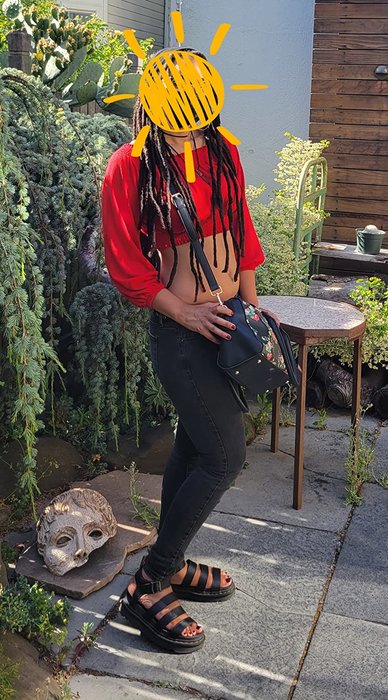 person styling the black leather Dr. Martens sandals