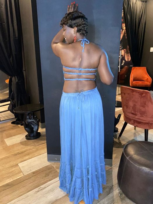 Reviewer showcasing the elegant back design of the blue dress