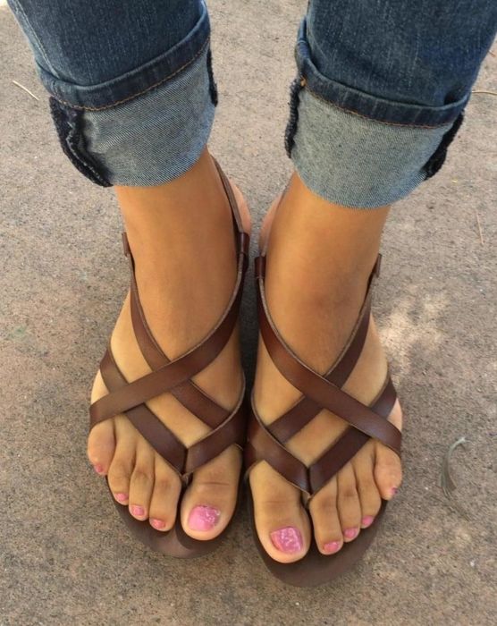 A reviewer wearing the brown sandals