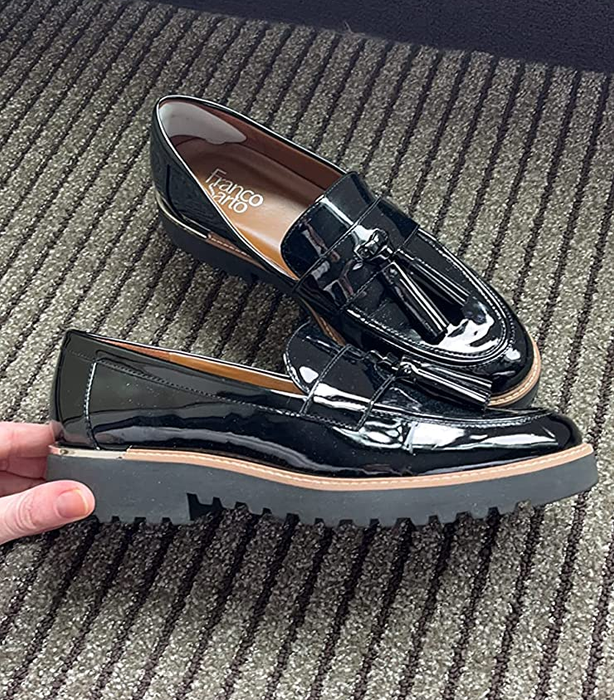 the black loafers with a hand showing a side view of their thick lug sole