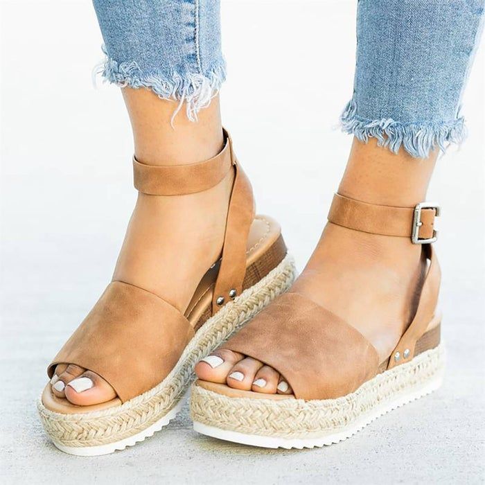 a model wearing the tan sandals