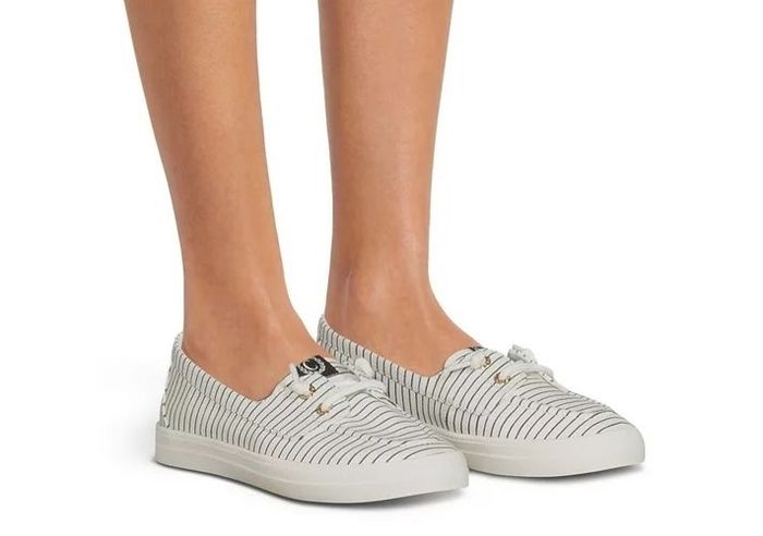 A model wearing the navy and white striped shoes