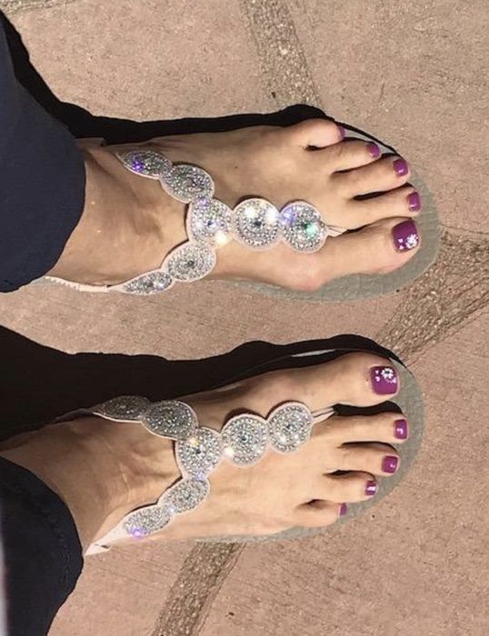 A reviewer wearing the sandals in the sunlight