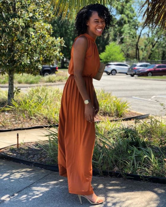 The dress showcased in a vibrant orange hue