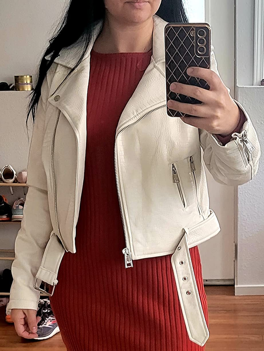 Photo of a reviewer modeling an elegant ivory jacket
