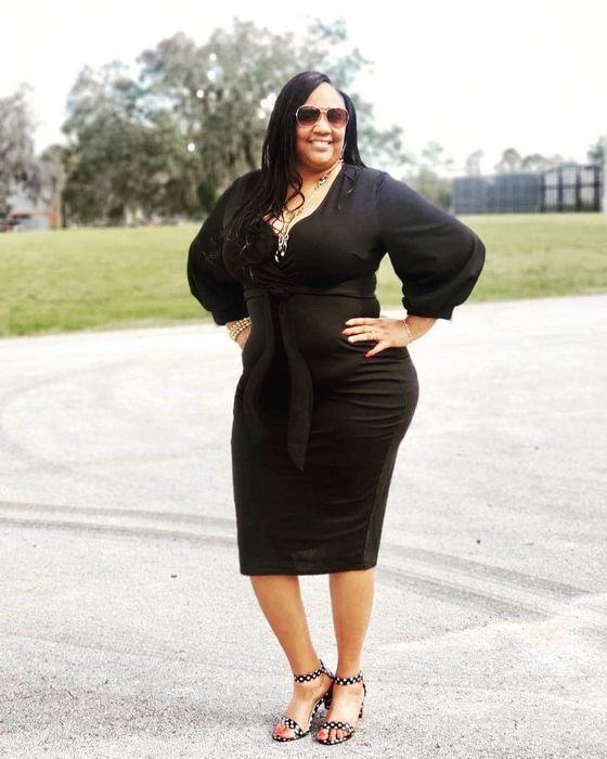 Reviewer wearing a sleek black dress