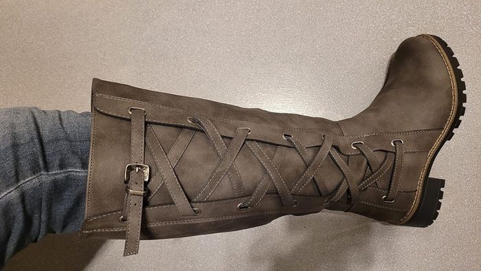 close-up of a reviewer wearing the gray motorcycle boot
