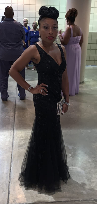 A reviewer in a long black dress
