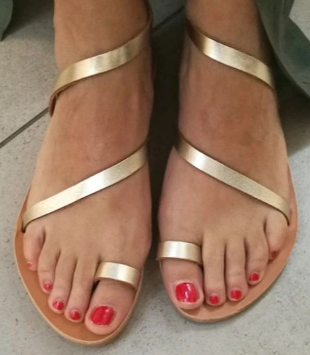 A model wearing the gold sandals