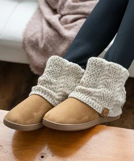A model styling the cable knit booties