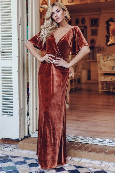 A model wearing the dress in a rust-colored shade