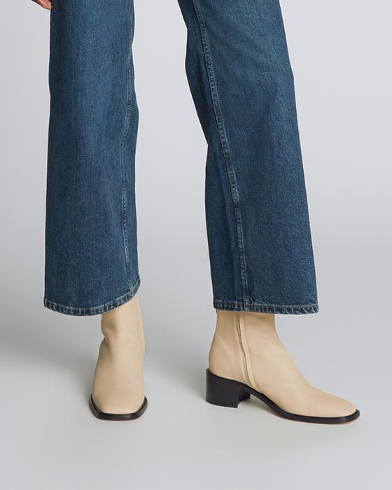 model showcasing the cream-colored boots