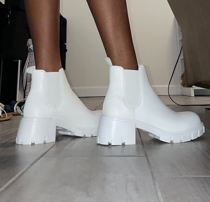 close-up of a reviewer wearing the white Chelsea boots