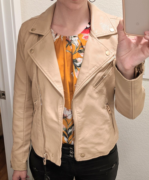 Photo of a reviewer wearing a beige jacket