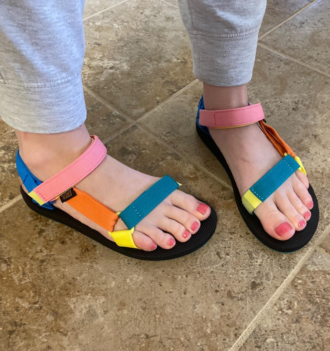 reviewer wearing colorful strappy sandals in pink, orange, and blue