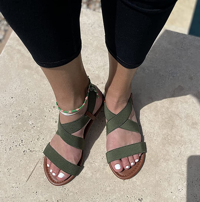 A reviewer wearing the green sandals