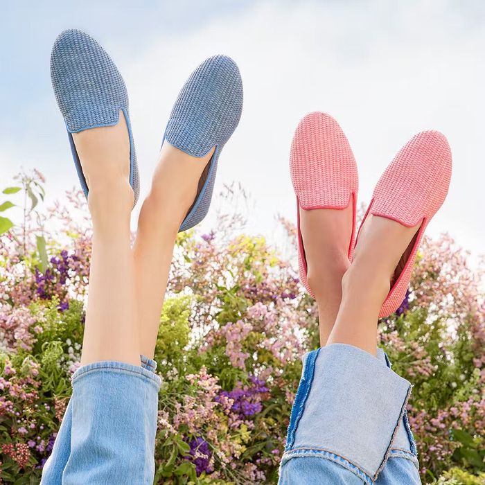 Two models are seen wearing Birdies woven flats, one in light blue and the other in bright pink.