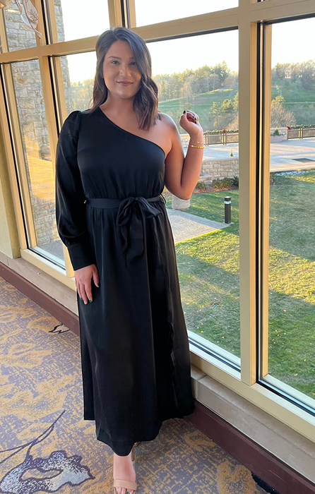 A reviewer posing in a black outfit