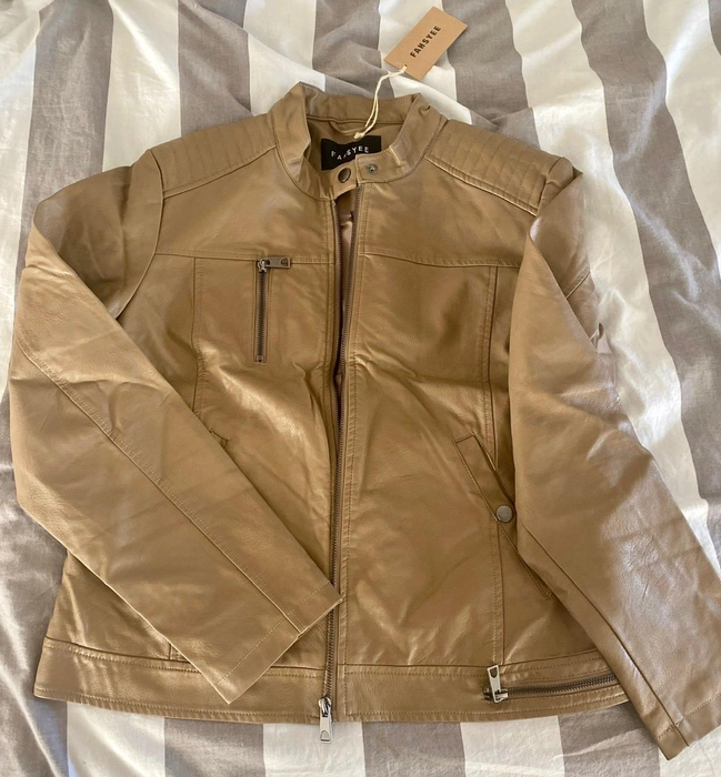 Photo of a reviewer wearing a beige jacket