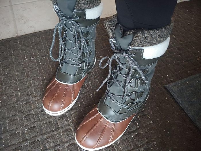 close-up of a reviewer wearing the tan khaki winter boots