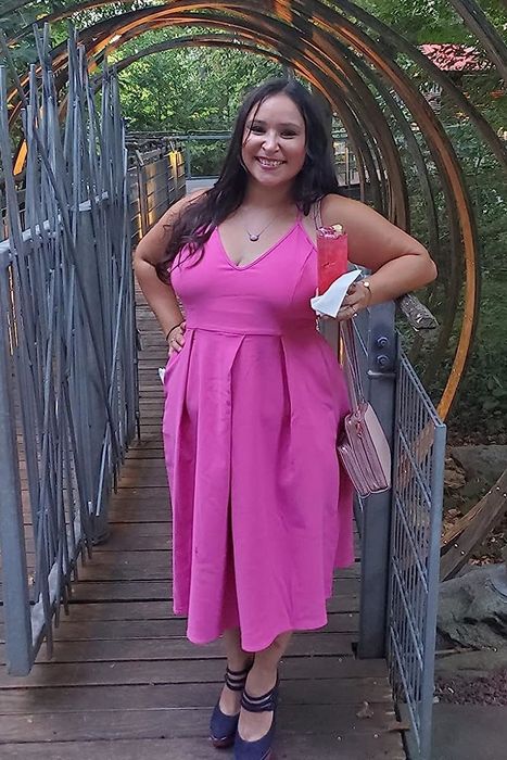 A reviewer modeling the dress in a soft pink shade