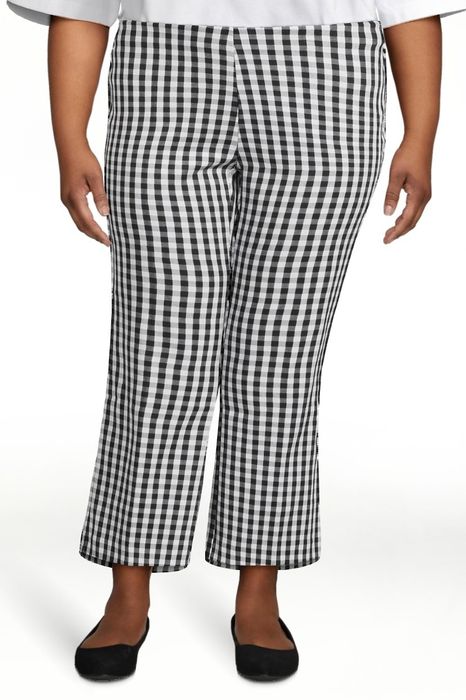 Model wearing black-and-white pants with black shoes