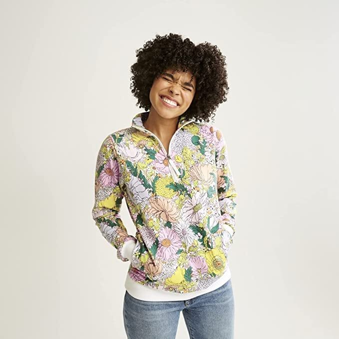 a model wearing the pink and yellow floral quarter-zip