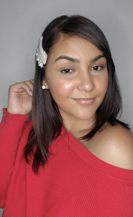 A reviewer sporting pearl barrettes in their hair