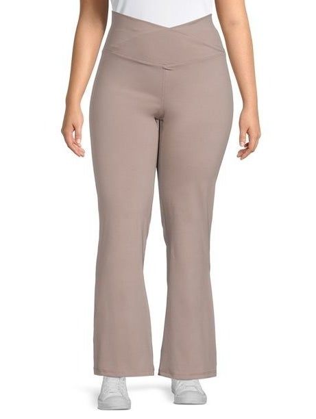 Model showcasing crossover waist flare yoga pants