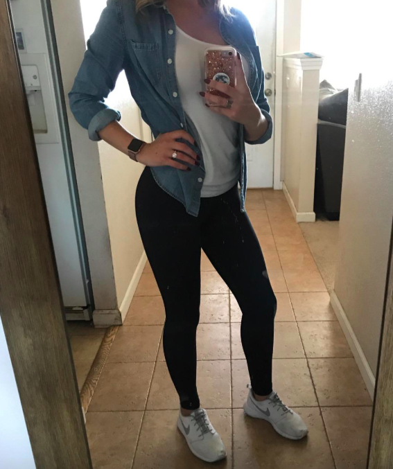 A reviewer modeling the black full-length version of the leggings
