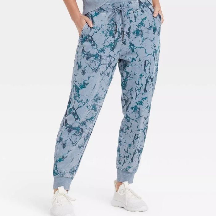 A model sporting the same mid-rise French terry joggers in a stylish blue marble print