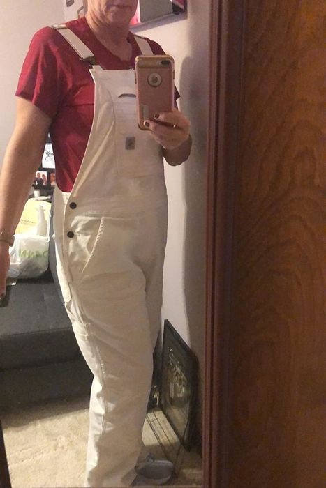 A reviewer modeling white overalls