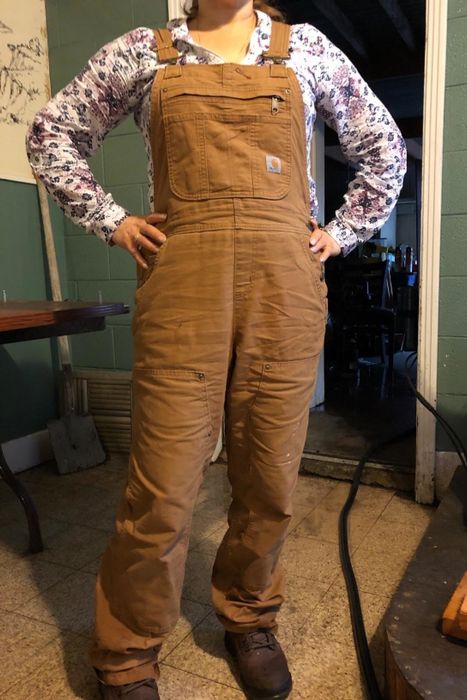 A reviewer showcasing tan overalls