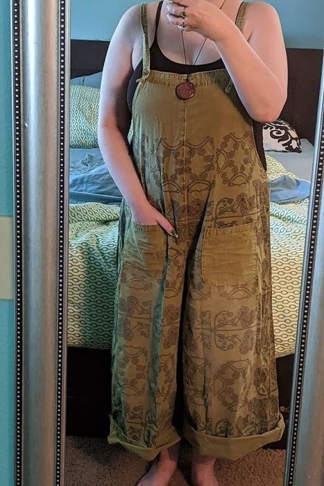 A reviewer styling brown overalls