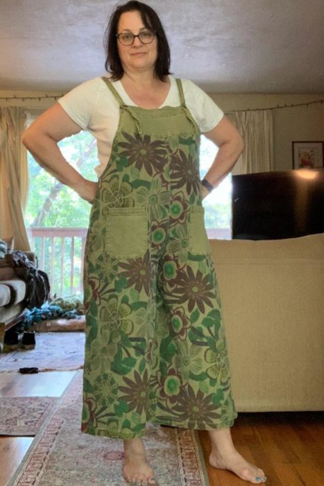 A reviewer modeling green overalls