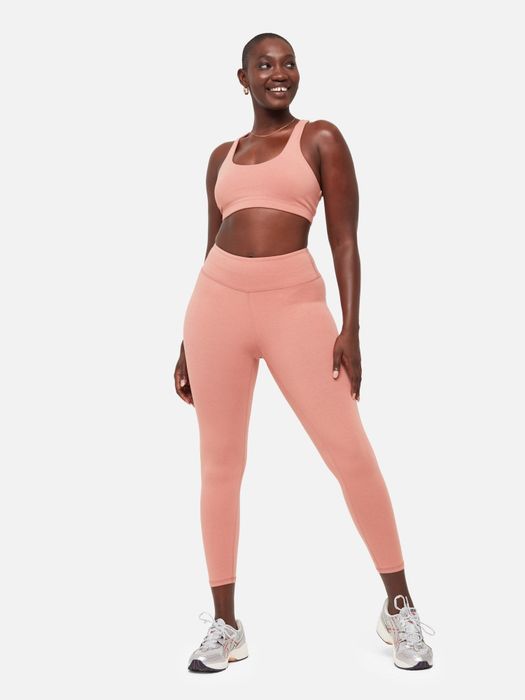 A model showcasing a coordinated pink leggings and sports bra set