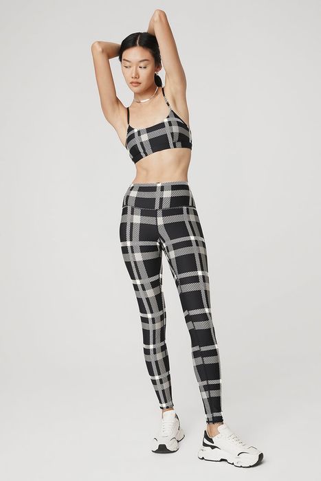 A model wearing a coordinated leggings and sports bra set