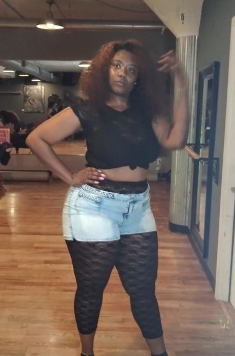 A reviewer's photo featuring lace leggings paired under jean shorts