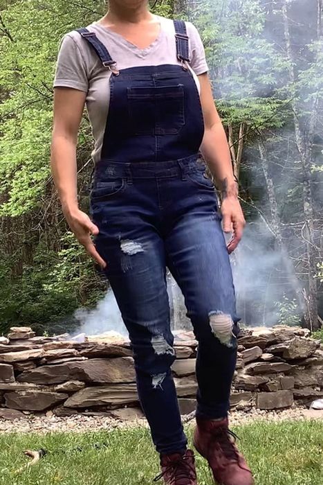 A reviewer modeling dark blue overalls