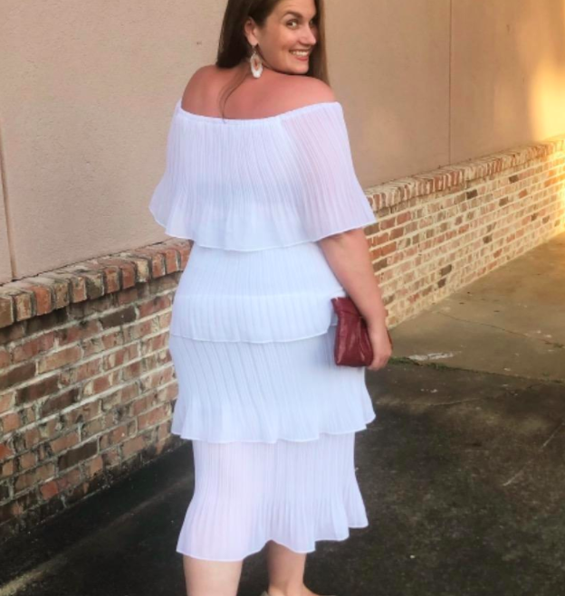 A customer review photo of them showing off the back of the dress.