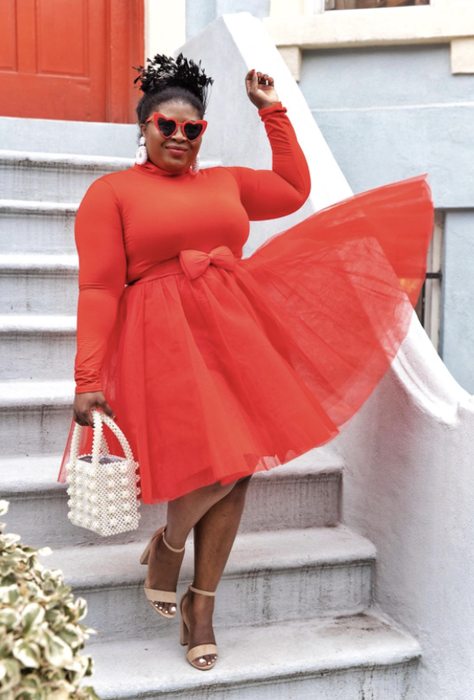a reviewer styling nude heels with a striking red dress
