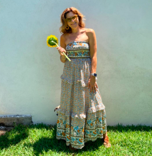 A customer review featuring a photo of them in the cream-colored dress.