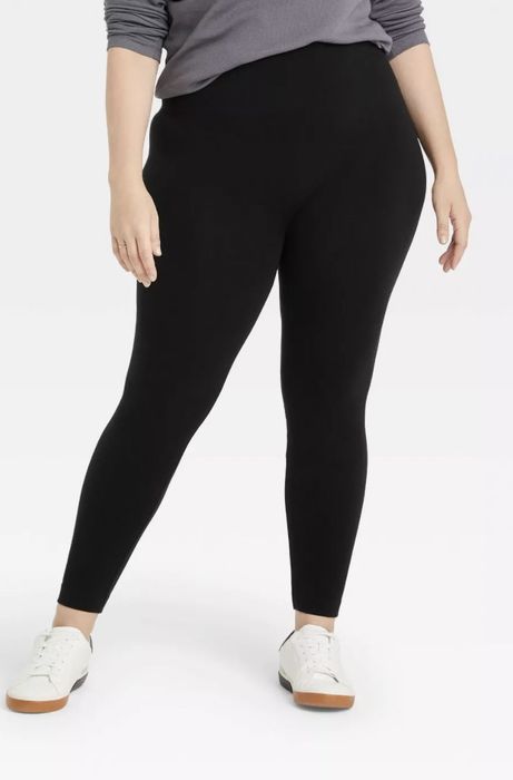 A model wearing black fleece-lined leggings paired with white sneakers