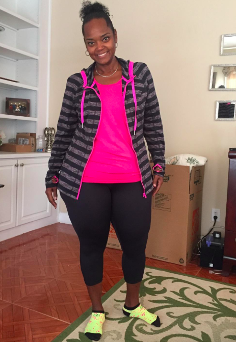 A reviewer wearing the black capri-style version of the leggings