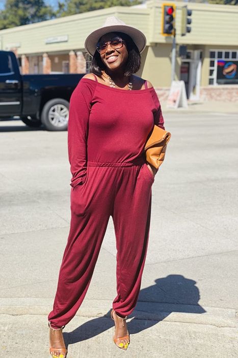 a reviewer photo wearing the red jumpsuit with heels