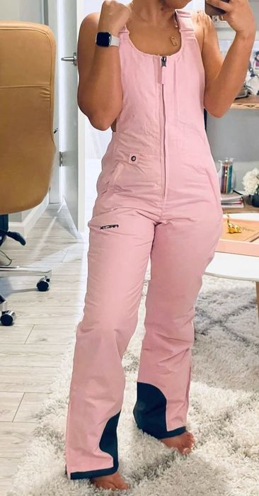 A reviewer modeling pink overalls
